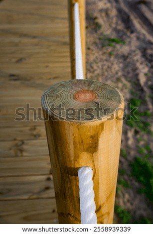Turned treated wood posts, side view.