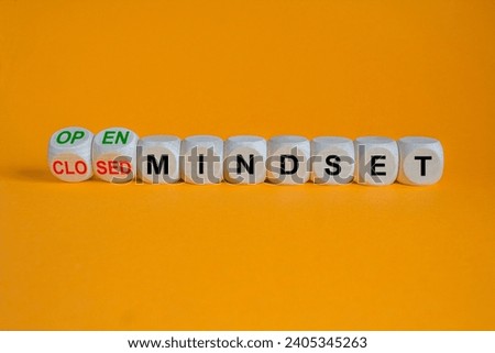 Turned wooden cubes and changes concept red words closed mindset to open mindset. Beautiful orange background, copy space. Business open or closed mindset concept.