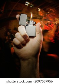 TURNERS FALLS, UNITED STATES - May 12, 2011: A Vertical Closeup Of The Right Hand Holding A Lit Zippo Lighter At A Rock Concert 