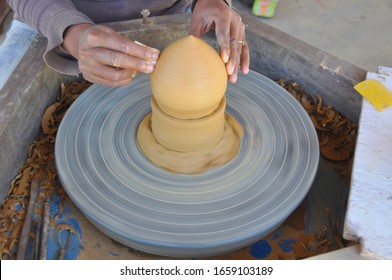 Turning ceramic items. Using this wheel to make pottery items like incense burners here in Siem Reap, Cambodia
