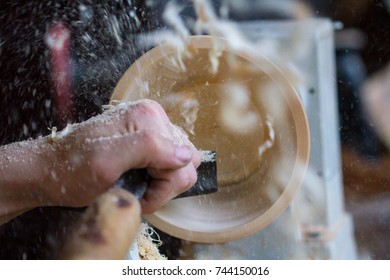 Turning the dishes on a lathe - Shutterstock ID 744150016