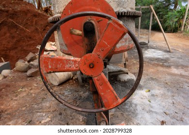 The Turning Lever Of The Cement Mixer Is Dirty Red.