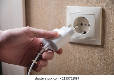 Turning off appliances that are not working saves energy. Unused phone chargers or power adapters. Plug the charging adapter into a European socket. Charging block yusb with interface type c - Shutterstock ID 2155732099