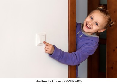 Turning off Light, Switch off Light, Save Energy, Energy Crisis concept. Child Girl Turns off the light. Copy space.