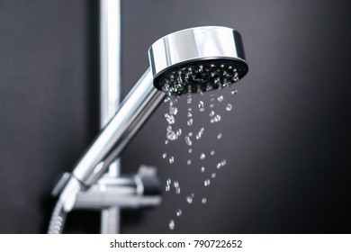 Turning off or on running water in shower. Last or first drops splash from faucet. Water consumption, bill, saving, shortage and ecology concept. Dripping shower.