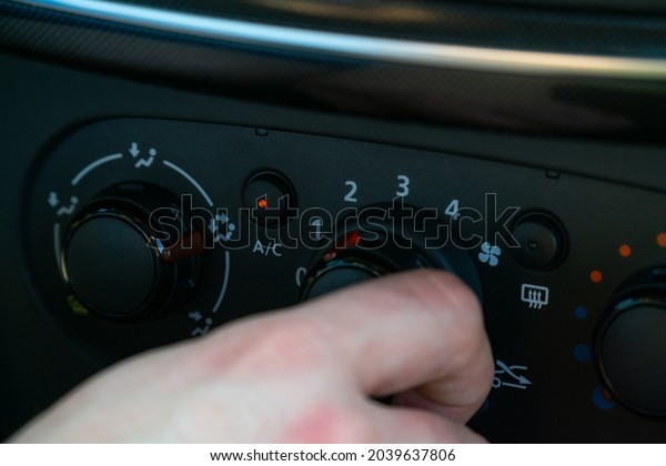 turning on the air\
conditioner in the car