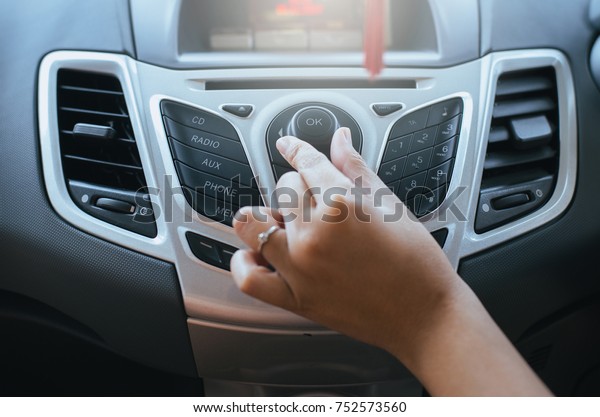Turning on car radio system,Button on dashboard in\
car panel