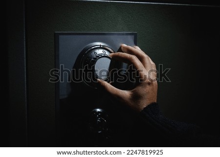 Turning a password on dial for open the safe box. Keep money and valuables in the vintage safe box steel. Stealing or keeping money and valuables safe.