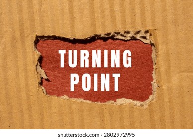 Turning point text appearing through a torn corrugated cardboard surface, symbolizing change, decision, and new direction