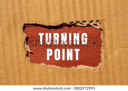 Turning point text appearing through a torn corrugated cardboard surface, symbolizing change, decision, and new direction