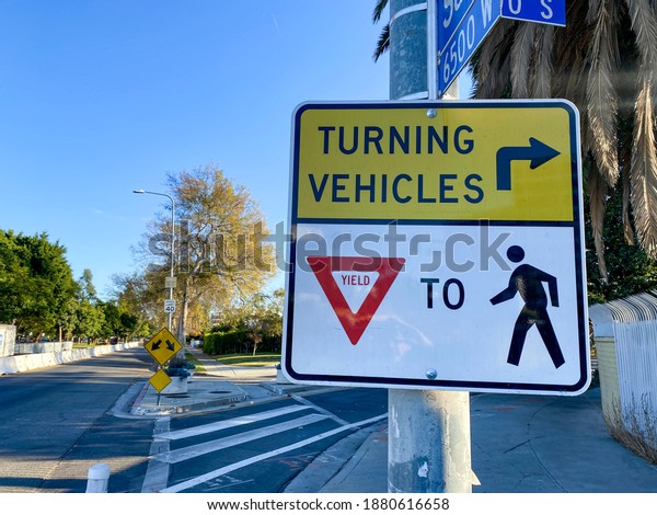 turning vehicles yield\
to pedestrian sign