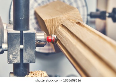 Turning wooden stair balusters. Wood stair balusters manufacturing process on a turning lathe with milling cutter. Close-up