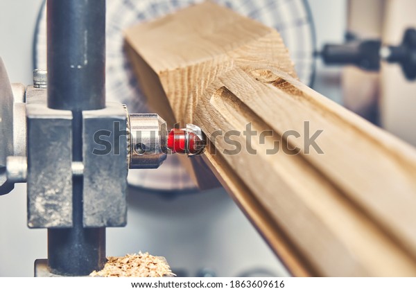 Turning
wooden stair balusters. Wood stair balusters manufacturing process
on a turning lathe with milling cutter.
Close-up