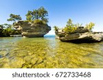 Turnip Rock on Lake Huron in Port Austin Michigan. An underwater view shows rocks under the clear surface of the water