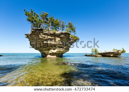 Turnip Rock on Lake Huron in Port Austin Michigan. An underwater view shows rocks under the clear surface of the water