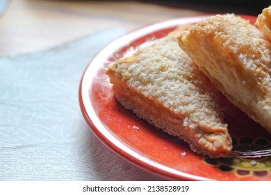 Turnovers Apple, Apple Pie, placed on an orange plate. with paper napkins Turnovers Apple is a popular dish in America