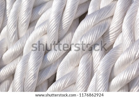 The turns of the white twisted nylon ship rope close up