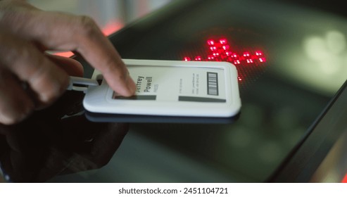Turnstile with touch panel for automatic identification in modern office building. African American man or businessman uses electronic pass card and passes through gates into the business center.