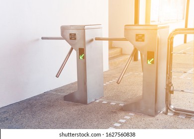 Turnstiles, focus on the left turnstile. Checkpoint. Automatic access control. Access system to enter building. Automatic electronic entrance. Entrance gate with turnstile.