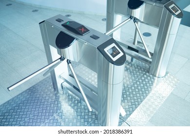 Turnstiles inside business center. Access restriction turnstiles. Concept - access to premises by passes. Restriction of entry without presenting a pass. Automatic turnstile with magnetic sensor