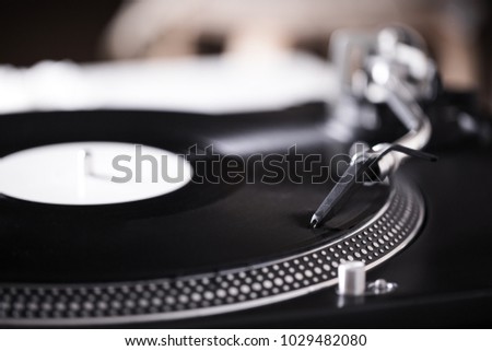 Turntable with black record and headshell, closeup