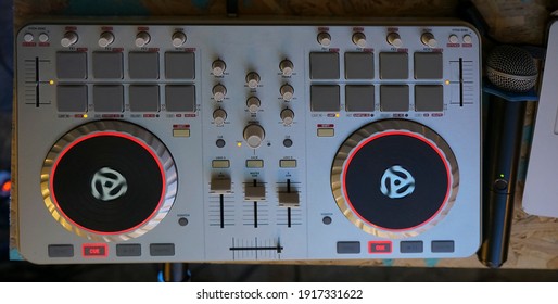 Turntable Console At Stage In The Night Club.  Sound Mixer Station, Microphone And Laptop At Club Party. DJ Mixer Controller. 