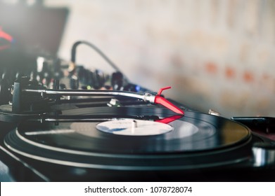 Turntable with needle on the record. DJing and party time.