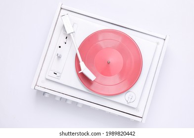 Turntable vinyl record player on white background. Sound technology for DJ to mix and play music. White vinyl record. Minimalism. Flat lay. Top view
