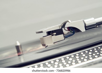 Turntable vinyl record player on a white background. Retro audio equipment for disc jockey. Sound technology for DJ to mix & play music. Black vinyl record. Vinyl record and needle close-up         - Shutterstock ID 736820986