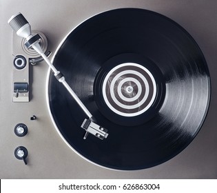 Turntable vinyl record player. Retro audio equipment for disc jockey. Sound technology for DJ to mix & play music. Black vinyl record                               