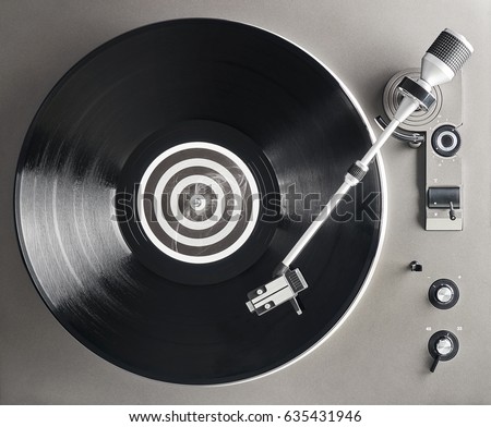 Turntable vinyl record player. Retro audio equipment for disc jockey. Sound technology for DJ to mix & play music. Black vinyl record                                                              