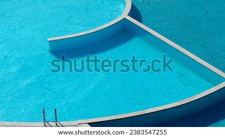 Turquoise and blue colored swimming pool which has two parts, one part is sweet water, the other salty water                