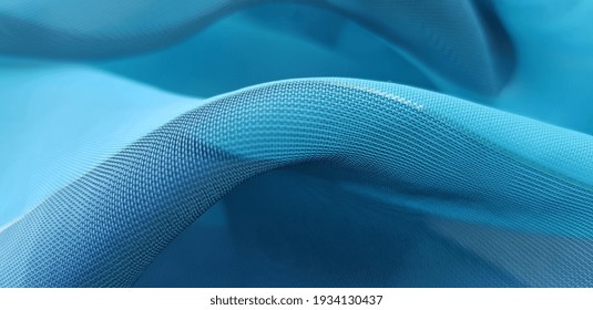 Turquoise blue, translucent fabric with a golden thread, in folds (texture). - Shutterstock ID 1934130437