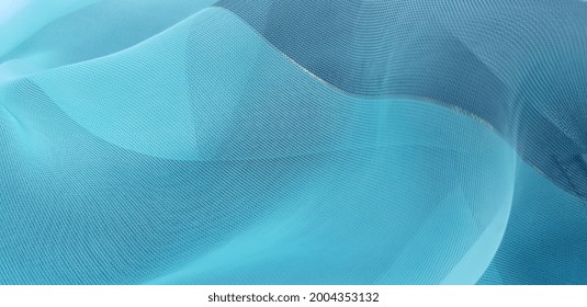 Turquoise blue translucent fabric with a golden thread, in slightly noticeable folds (texture). - Shutterstock ID 2004353132