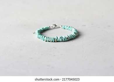 Turquoise bracelet. Bracelet made of stones on hand from natural stone Turquoise. Bracelet made of natural stones. Handmade jewelry. Handmade bracelets on light modern background.