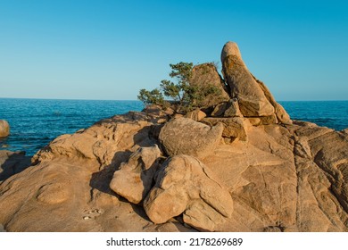 Turquoise Calm Water With Wave With Sand Beach Background Smooth And Rough Rocks And Corals Landscape Cloudy View In Sunset. Concept Summer