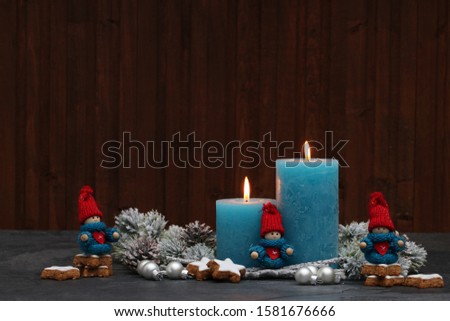 Turquoise candles with Christmas figures