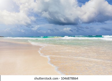 Turquoise Caribbean ocean with cloudscape and sun in Tulum, Mexico