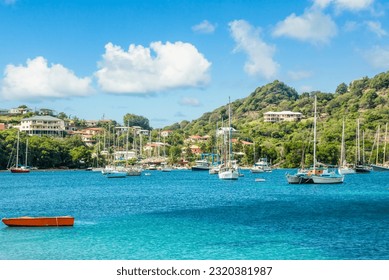 Turquoise colored sea with ancored yachts and boats in the lagoon at Carriacou island, Grenada, Caribbean sea