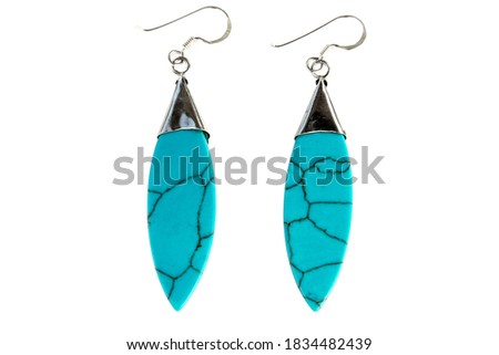 Turquoise earring and silver isolated on white background. Turquoise stone and silver earrings with leaf shape isolated
