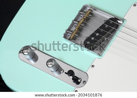Turquoise electric guitar bridge, pickups, selector, pickguard, volume and tone controls