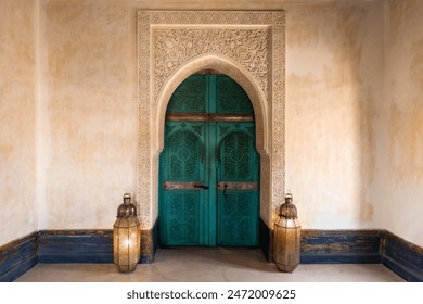 Turquoise green blue traditional Moroccan arch door background, ornamental carved wood, interior, The Tower at Le Jardin Secret, Marrakech, Morocco. central composition with decorative lanterns - Powered by Shutterstock