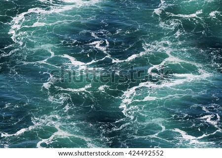 Turquoise green Seawater with sea foam as seamless background