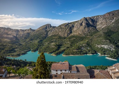 Turquoise lake in the mountains and valley. Sunny landscape and man made lake. Guadalest, Spain
