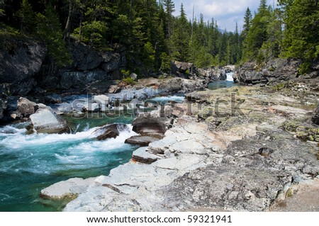 Turquoise river flowing towards Lake McDonald at Glacier National Park