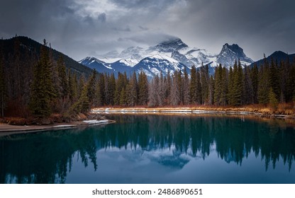 Turquoise river is reflecting the snow capped mountains and evergreen forest in the canadian rockies - Powered by Shutterstock