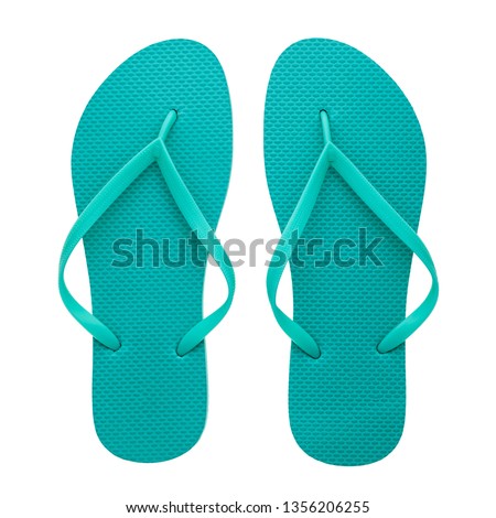 Turquoise rubber flip-flops isolated over white background, pair of thongs, shot above.