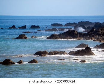 Turquoise sea with rocky shore.