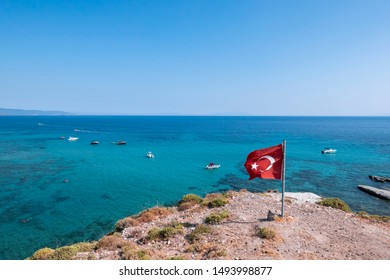 Turquoise Sea View From The Top Of The Cliff. Summer In Turkey. Turkish Flag On The Beach. 