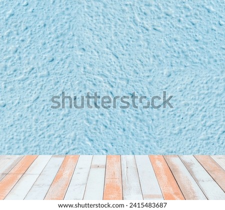 Turquoise Textured Wall with Striped Wood Floor, A bright turquoise textured wall above a wooden floor with striped white and orange planks, ideal for vibrant backdrops.